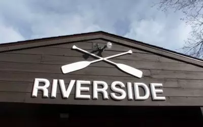 close-up of Riverside Canoe name on building